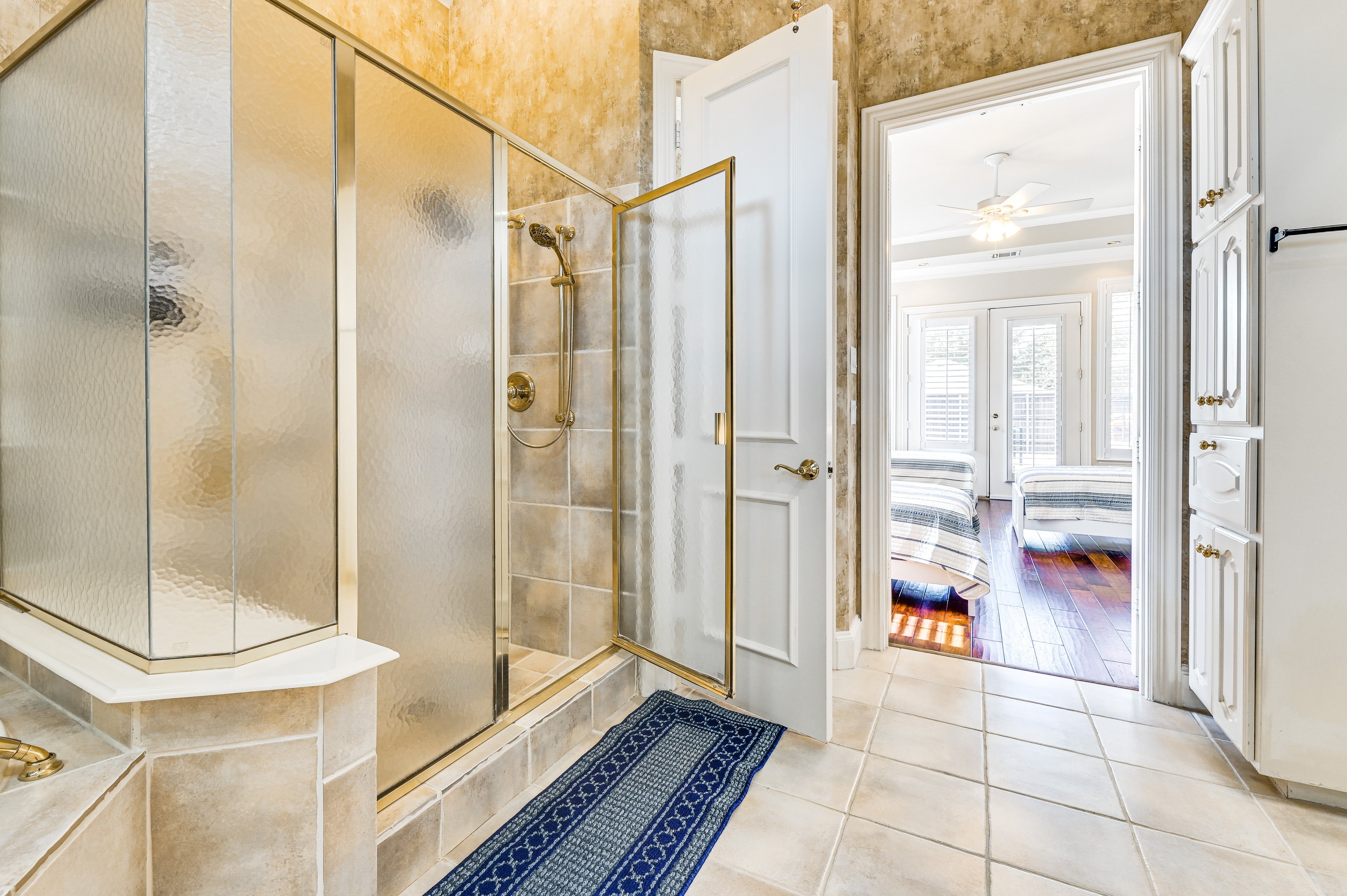 Shared Bedroom 1 — shared bathroom with gold-framed glass shower